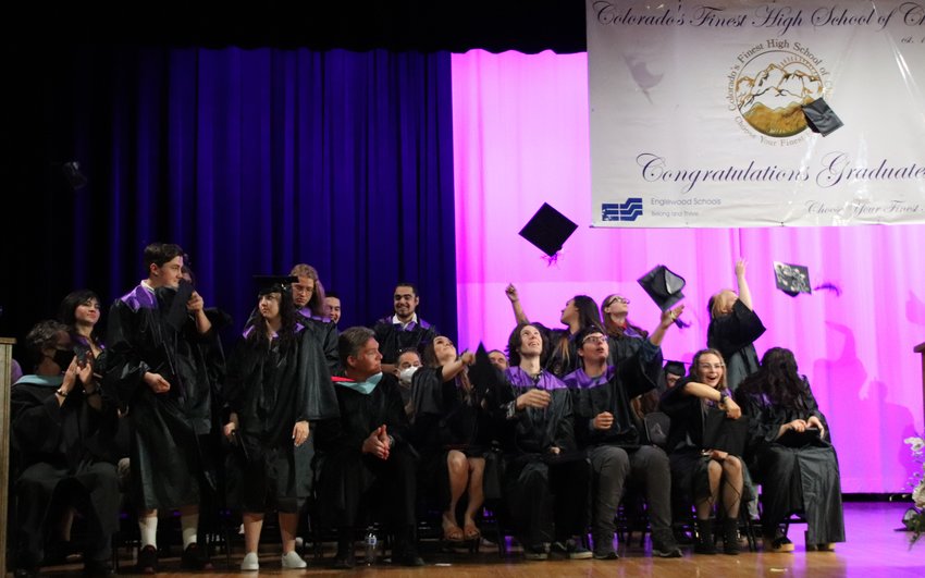 Graduating students throw their caps into the air at the end of the graduation ceremony at Colorado's Finest High School of Choice.